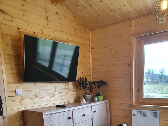 Nakryty stół w jadalni domku, obok pies gospodarzy