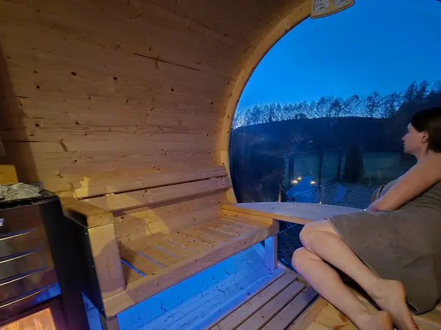 Odpoczynek w saunie typu beczka z widokiem przez panoramiczne okno
